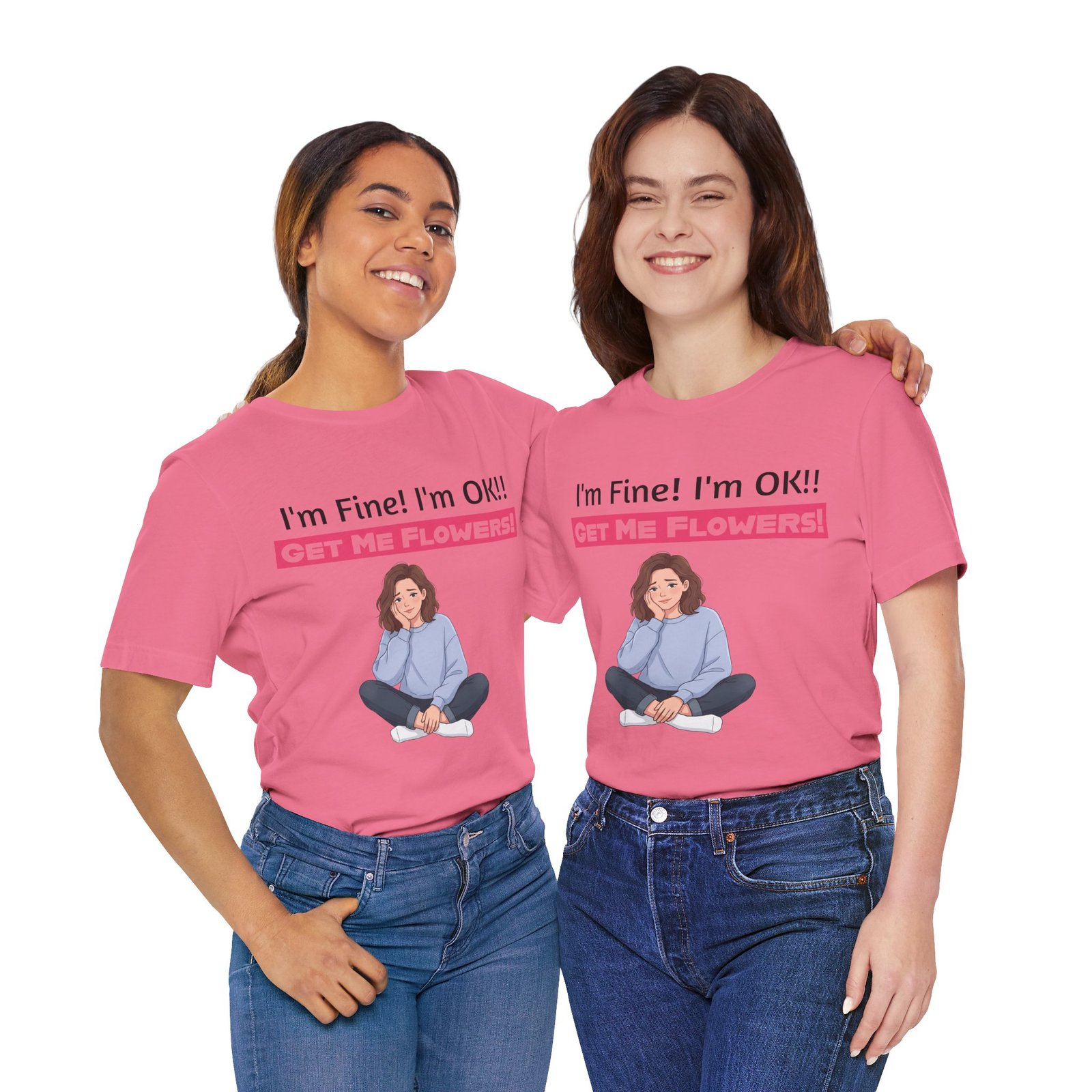 Two women smiling while wearing pink funny T-shirts that say "I'm Fine! I'm OK!! GET ME FLOWERS!" with a cartoon graphic.