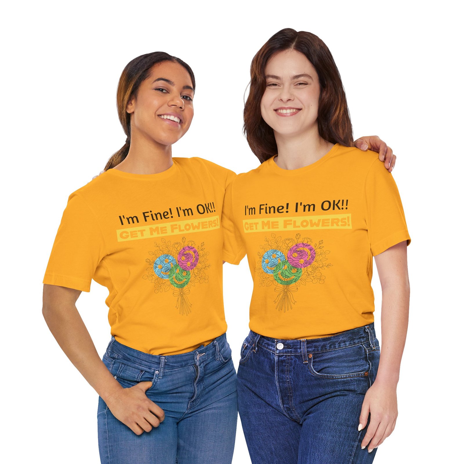 Two women smiling while wearing yellow funny t-shirts with colorful flower graphics and the text I'm Fine! I'm OK!!