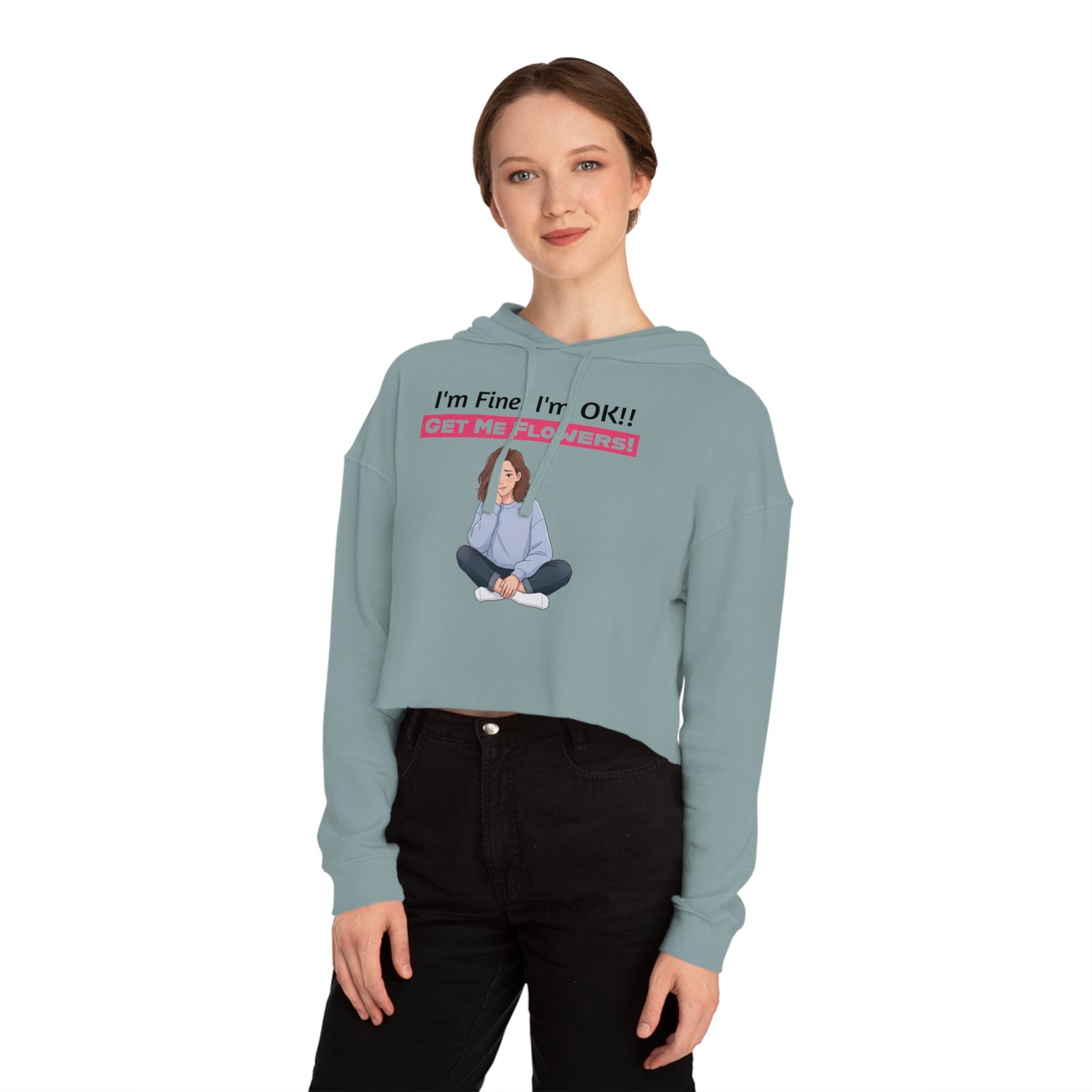 Woman wearing a light blue cropped hoodie featuring a girl graphic and text: I'm Fine! I'm OK!! Get Me Flowers!