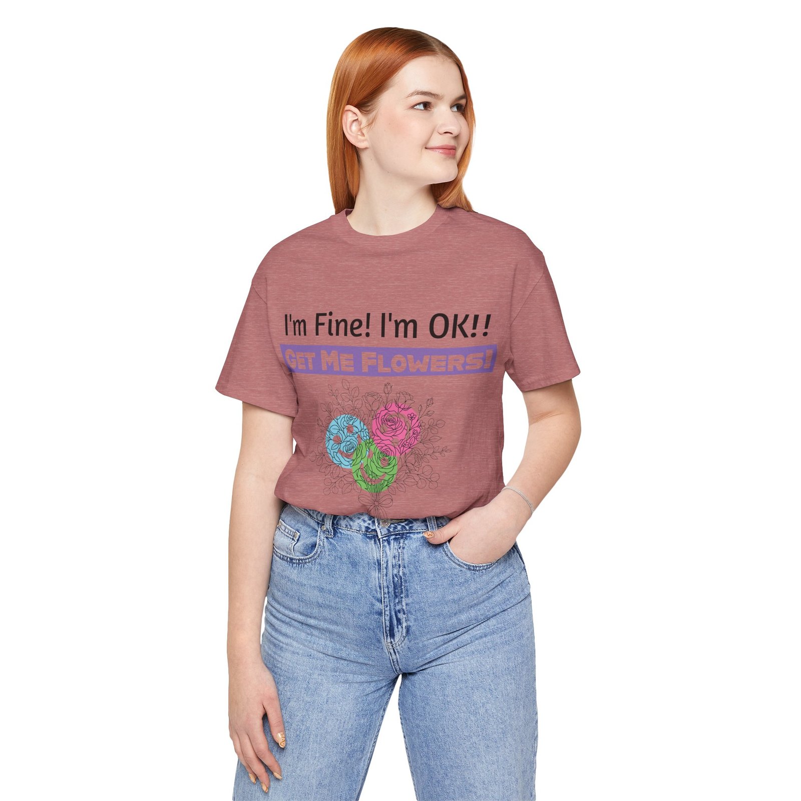 Woman wearing a mauve graphic t-shirt featuring the sarcastic text "I'm Fine! I'm OK!! GET ME FLOWERS!" and colorful flowers.