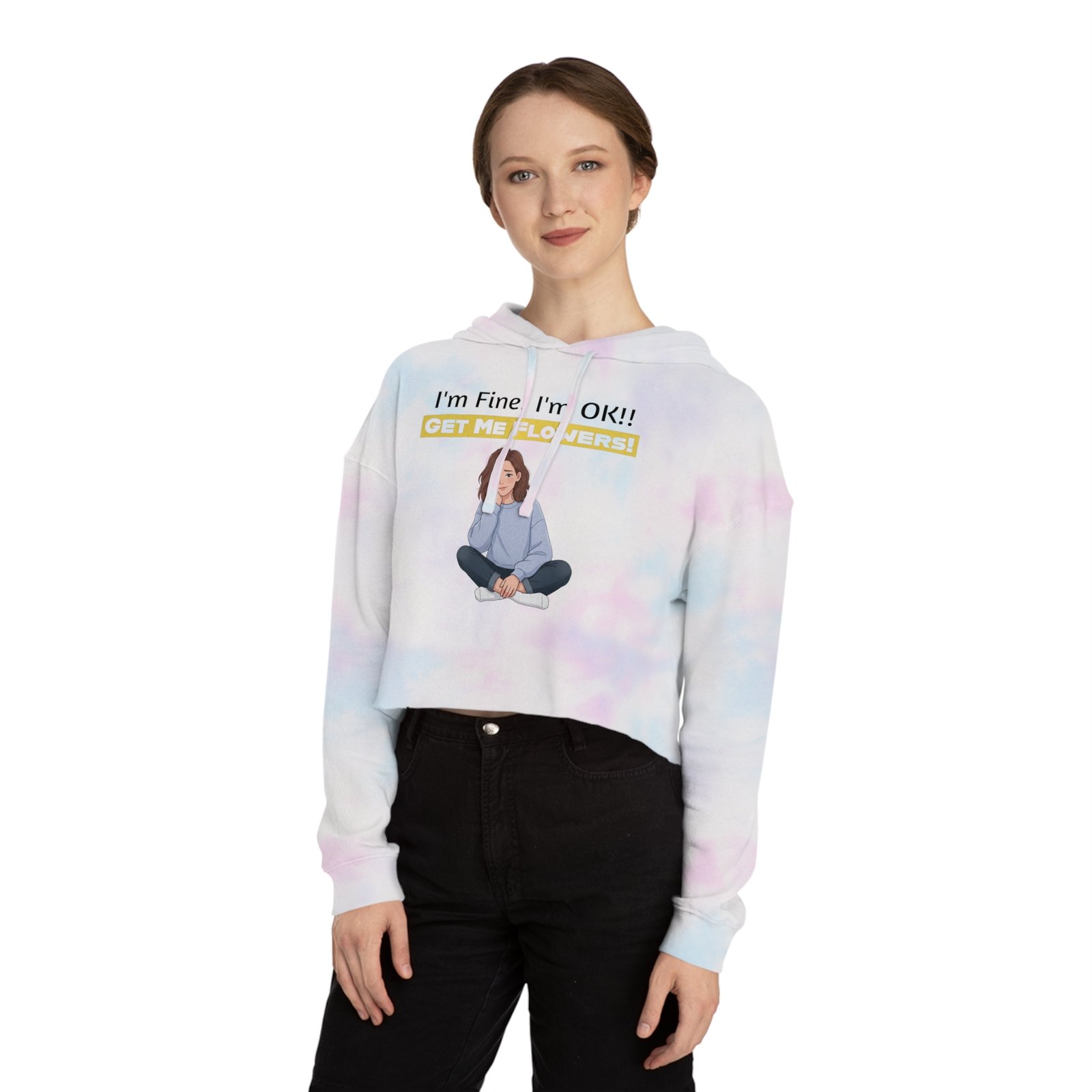 Woman wearing a white and pastel tie-dye cropped hoodie with "I'm Fine! I'm OK!! GET ME FLOWERS!" text and graphic.