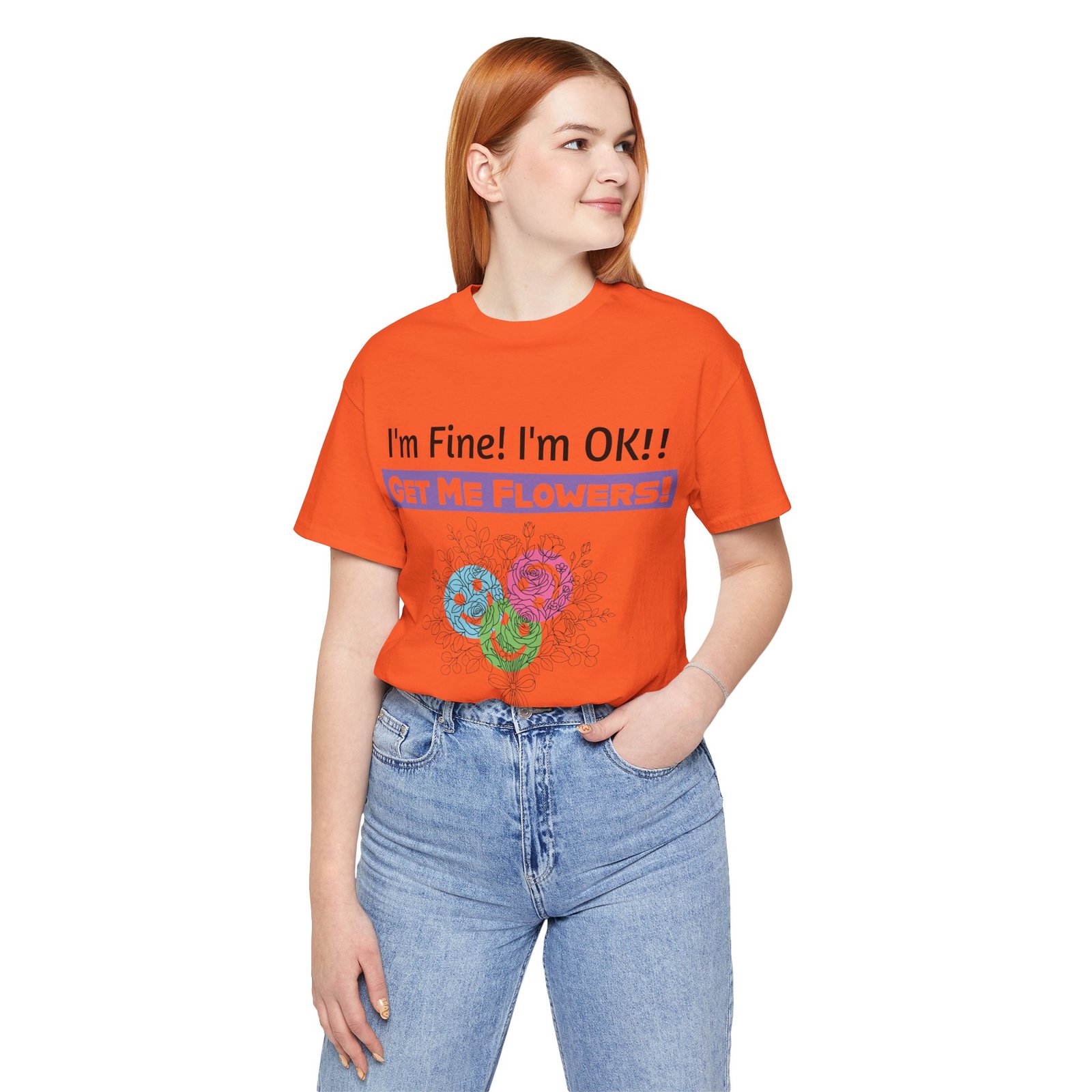 Woman wearing an orange graphic t-shirt with 'I'm Fine! I'm OK!! GET ME FLOWERS!' and colorful floral print.