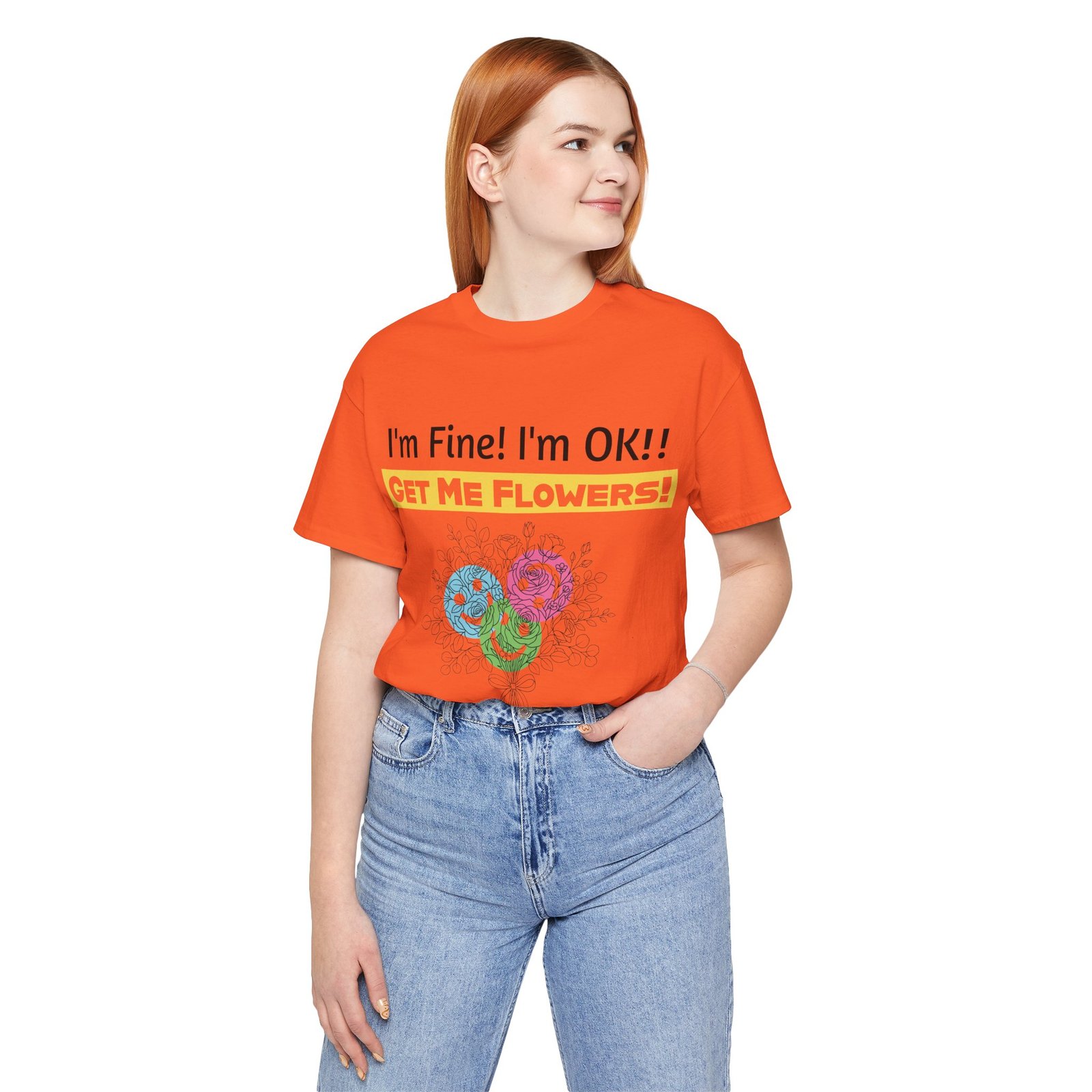 Woman wearing an orange t-shirt with colorful flower graphics and the text "I'm Fine! I'm OK!! GET ME FLOWERS!"